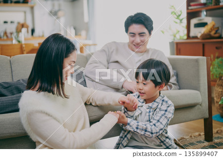 A family relaxing in the living room A family relaxing in the living room 135899407