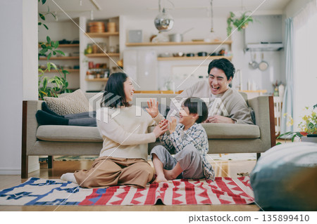 A family relaxing in the living room A family relaxing in the living room 135899410