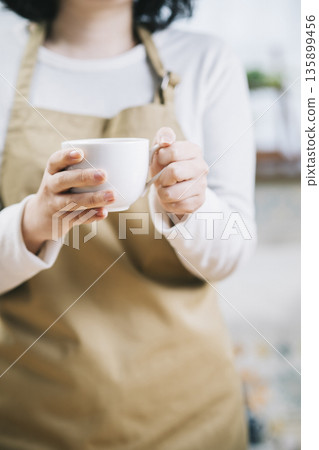 一個女人用一杯咖啡 一個女人用一杯咖啡 135899456