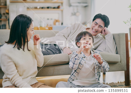 A family relaxing in the living room A family relaxing in the living room 135899531