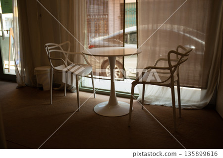 Minimal Cafe Chairs by the Window in Soft Light Minimal Cafe Chairs by the Window in Soft Light 135899616