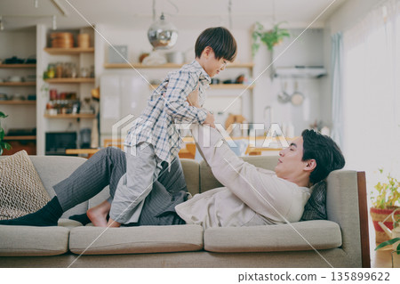 Parent and child playing in the living room 135899622