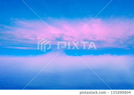 Seascape in the early morning. Sunrise over the sea in pastel color. Fog over the sea. View from above Seascape in the early morning. Sunrise over the sea in pastel color. Fog over the sea. View from above 135899804