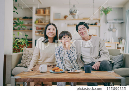 A family relaxing in the living room A family relaxing in the living room 135899835