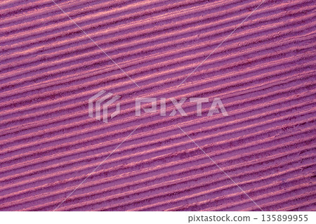 Top view of a colorful striped arable field. Rural nature. Purple-colored earth background Top view of a colorful striped arable field. Rural nature. Purple-colored earth background 135899955