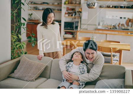 A family relaxing in the living room 135900227
