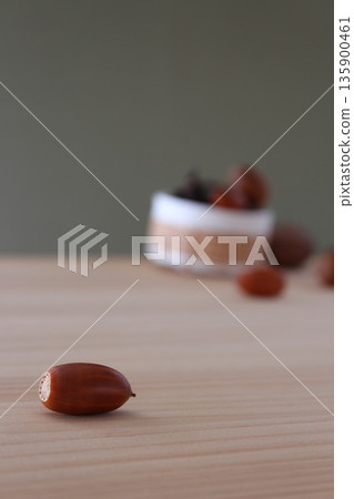 Autumn background image | Acorns in the foreground and a blurred basket (for vertical, smartphone, and social media use) Autumn background image | Acorns in the foreground and a blurred basket (for vertical, smartphone, and social media use) 135900461