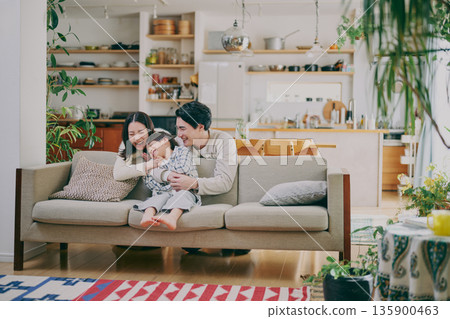 A family relaxing in the living room 135900463