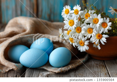 Blue easter eggs with daisies rustic table 135900564