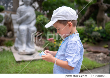 Curious Child Enthusiastically Captures Essence Of Temple Serenity in Bangkok, Thailand Curious Child Enthusiastically Captures Essence Of Temple Serenity in Bangkok, Thailand 135900889