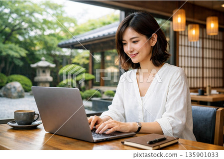 Japanese woman working remotely in a cafe Japanese woman working remotely in a cafe 135901033
