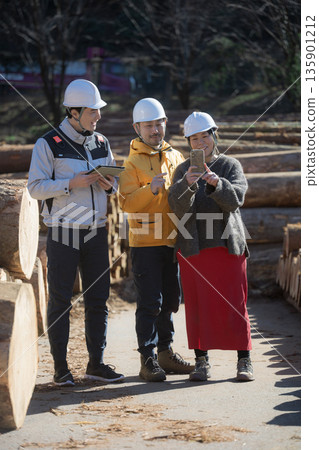 Clients inspecting the timber and building materials used to build custom-built homes, and the idea of building their own home from building materials. 135901212