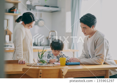 Children studying and parents watching 135901297