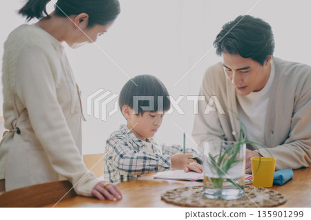 Children studying and parents watching Children studying and parents watching 135901299