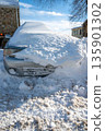 Siilver car buried in snow in rural setting blue sky winter scene copy space 135901302