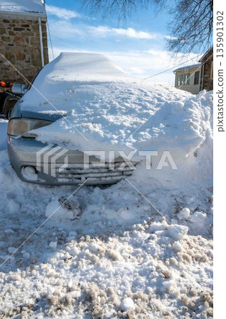 Siilver car buried in snow in rural setting blue sky winter scene copy space Siilver car buried in snow in rural setting blue sky winter scene copy space 135901302