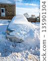 Siilver car buried in snow in rural setting blue sky 135901304