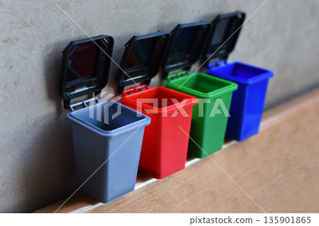 Colorful recycling toy boxes, plastic classification trash cans as children's educational toys. Ecology and next generation concept Colorful recycling toy boxes, plastic classification trash cans as children's educational toys. Ecology and next generation concept 135901865
