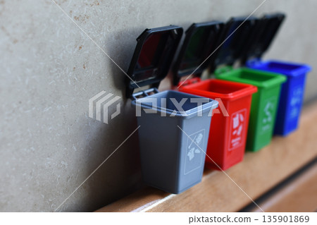 Colorful recycling toy boxes, plastic classification trash cans as children's educational toys. Ecology and next generation concept Colorful recycling toy boxes, plastic classification trash cans as children's educational toys. Ecology and next generation concept 135901869