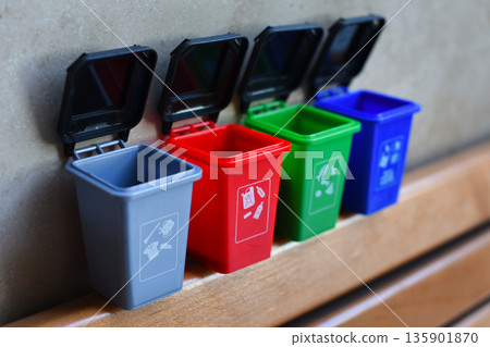Colorful recycling toy boxes, plastic classification trash cans as children's educational toys. Ecology and next generation concept Colorful recycling toy boxes, plastic classification trash cans as children's educational toys. Ecology and next generation concept 135901870