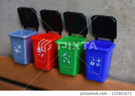 Colorful recycling toy boxes, plastic classification trash cans as children's educational toys. Ecology and next generation concept Colorful recycling toy boxes, plastic classification trash cans as children's educational toys. Ecology and next generation concept 135901871