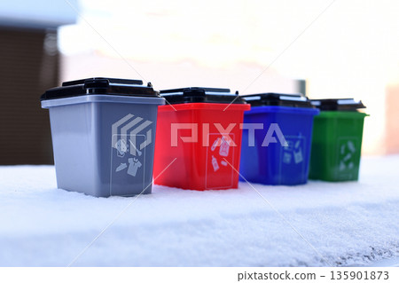Colorful recycling toy boxes standing in snow, plastic classification trash cans as children's educational toys. Ecology and next generation concept Colorful recycling toy boxes standing in snow, plastic classification trash cans as children's educational toys. Ecology and next generation concept 135901873