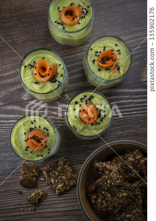 Smoked salmon shot glasses guacamole served with homemade crackers 135902176
