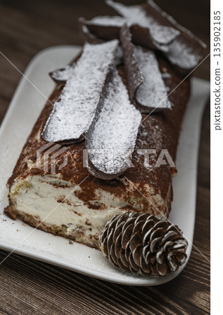 Tiramisu Tronchetto Dessert, Italian Yule Log Christmas dessert with chocolate bark Tiramisu Tronchetto Dessert, Italian Yule Log Christmas dessert with chocolate bark 135902185