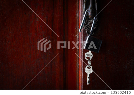 House key left hanging on an empty door symbolizes abandonment, separation, loneliness, House key left hanging on an empty door symbolizes abandonment, separation, loneliness, 135902410