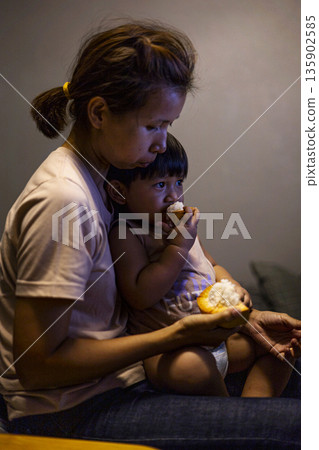 Mom And Toddler Are Eating Santol, A candid documentary shot of mom and toddler sharing santol, seeds on tiny fingers, ideal for parenting ad or pure joy showcase. Mom And Toddler Are Eating Santol, A candid documentary shot of mom and toddler sharing santol, seeds on tiny fingers, ideal for parenting ad or pure joy showcase. 135902585