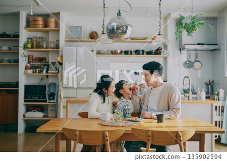 Family relaxing in the dining room Family relaxing in the dining room 135902594