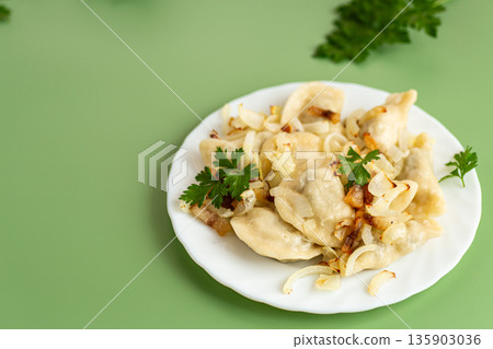 Traditional Ukrainian varenyky with golden onion and herbs Traditional Ukrainian varenyky with golden onion and herbs 135903036