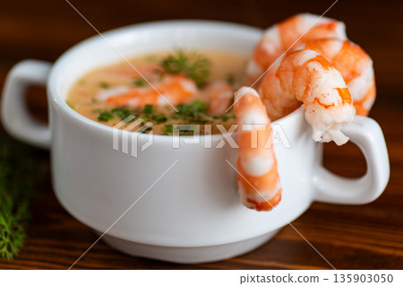 Gourmet seafood soup featuring tender shrimp and aromatic spices Gourmet seafood soup featuring tender shrimp and aromatic spices 135903050