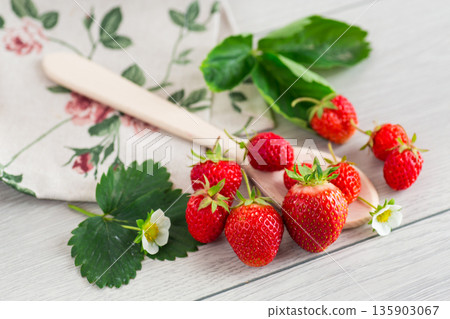 Juicy strawberries close-up on a light wooden table 135903067