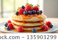 Stack of golden pancakes with maple syrup, fresh strawberries, blueberries, and raspberries. Delicious breakfast food 135903299