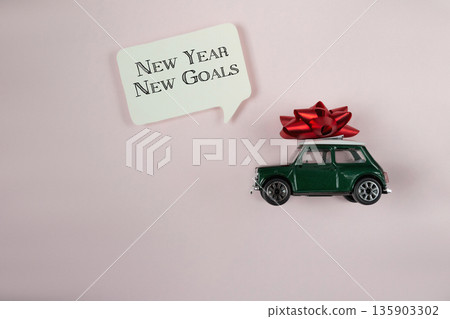 Green toy car with a red bow on top of it 135903302