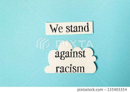 Blue background with a white cloud and the words We stand against racism Blue background with a white cloud and the words We stand against racism 135903354