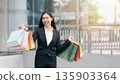 Happy woman with shopping bags enjoying in shopping. 135903364