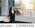 Happy woman with shopping bags enjoying in shopping. 135903368