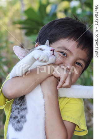 Asian little boy holding cat in his arms Asian little boy holding cat in his arms 135903460