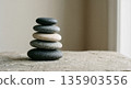 Stack of balanced gray and white stones. Tranquil spiritual zen concept for meditation, relaxation, and harmony. Spa and wellness background. 135903556