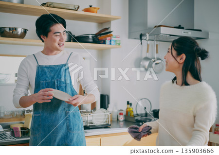 A couple tidying up the dishes A couple tidying up the dishes 135903666