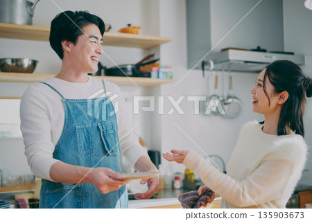 一對夫婦正在收拾碗筷 135903673