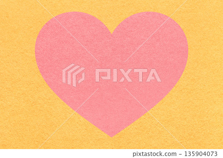 Pink heart on light yellow paper texture background with copy space for Valentines Day banner, template or greeting card 135904073
