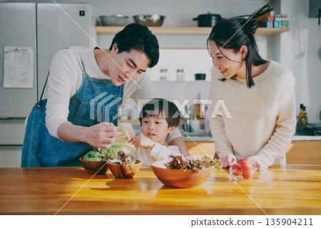 Parents who cook in the kitchen 135904211