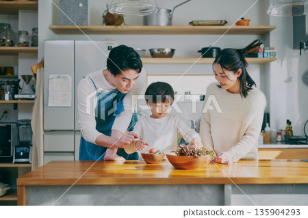 Parents who cook in the kitchen 135904293