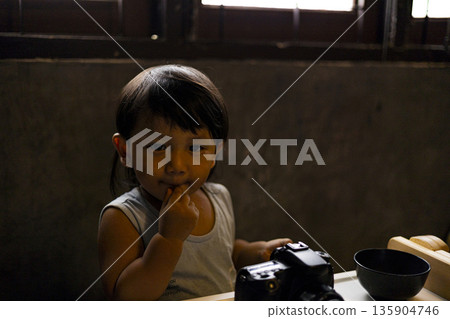 Toddler Is Playing With A Camera, Background for advertising and wallpaper in education and lifestyle scene. 135904746