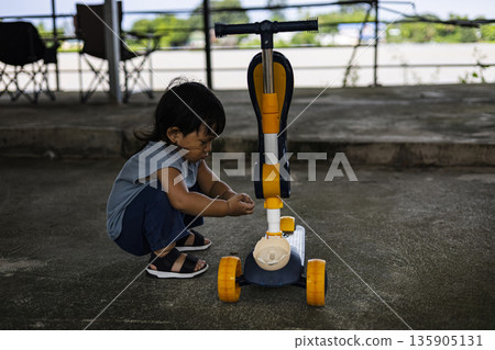Focused Toddler Fixing Scooter, A sharp ad photo of toddler fixing scooter, tiny hands on tools in bright light, perfect for child growth campaign or curious mechanic documentary. Focused Toddler Fixing Scooter, A sharp ad photo of toddler fixing scooter, tiny hands on tools in bright light, perfect for child growth campaign or curious mechanic documentary. 135905131