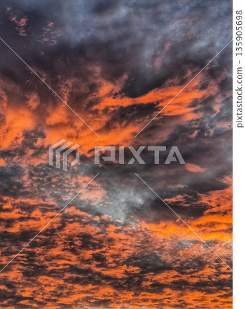 Dramatic Sunrise Clouds. Fiery Sky at Dawn. Orange and Blue Sky Panorama. Colorful Cloudscape Dramatic Sunrise Clouds. Fiery Sky at Dawn. Orange and Blue Sky Panorama. Colorful Cloudscape 135905698