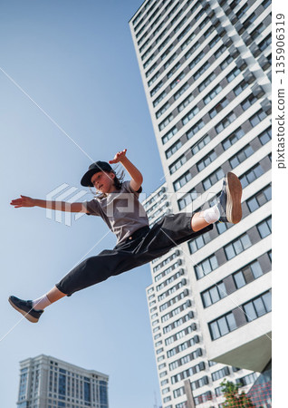 A girl jumps on a gymnastic trampoline. A girl jumps on a gymnastic trampoline. 135906319